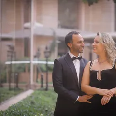 An elegant pre-wedding portrait in a beautiful garden setting. The couple is dressed formally, and my focus is on capturing the genuine, happy glance they share with each other.
