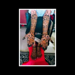 The complete bridal mehendi for a South Indian wedding, with coordinated designs on the hands and feet. The patterns are intricate and full, perfect for a bride.