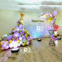 For a touch of modern glamour, I use high-impact backdrops like this iridescent sequin wall. Paired with a sophisticated balloon arrangement in purple, silver, and gold, it creates a stunning photo opportunity for any birthday or private party.