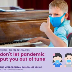 A young student gives a thumbs-up during his piano lesson, showing his enjoyment and confidence. We make learning accessible and safe, offering both online and in-person options for kids.