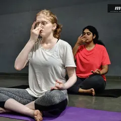 After the active part of the class, we transition to pranayama. This close-up shows the focus required for alternate nostril breathing, a technique I teach to balance the body's energy and prepare the mind for meditation.