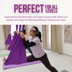 Aerial yoga is perfect for all levels. Here, a student uses the hammock to support a deep hamstring stretch in a variation of Hanumanasana (split pose). The fabric provides stability, allowing you to refine your posture and explore new depths in your practice.