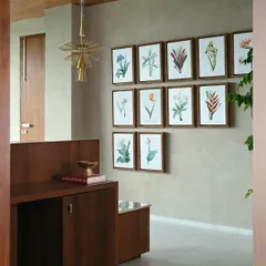 Architectural Digest India featured our work on the AMC Chairman's office. This image from the feature shows the elegant entryway with its custom art and lighting.