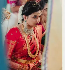A beautifully framed shot of the bride looking on during the ceremony, capturing her elegance and traditional jewelry.