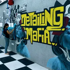 Here I am adding the final touches to the garage graffiti. Working with spray paint on a rough concrete surface requires a different technique, but I love the raw, powerful result.