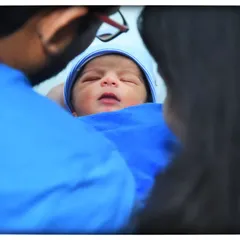A beautiful family portrait capturing the parents' love and wonder as they gaze at their newborn. I focus on creating a relaxed atmosphere so these natural, emotional moments can unfold.