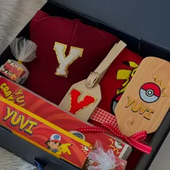 A look inside the Pokémon 'Box of Happiness'. I included a personalized cap with the initial 'Y', a custom luggage tag, and a themed crayon box.