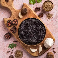 A top-down shot of Aazol's traditional Maharashtrian chutney. We styled it on a wooden board surrounded by its core ingredients like garlic, kokum, and whole spices to tell a story of its authentic recipe.