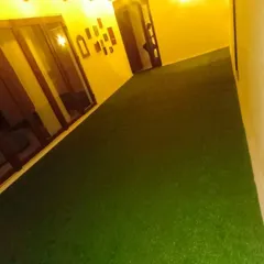 No space is too large or awkwardly shaped for an artificial grass installation. I covered this entire corridor to create a seamless, lush green carpet that brightens up the area, especially at night.