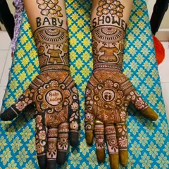 I love creating special mehandi for baby showers. This design features "Baby Shower" text, cute motifs like a teddy bear and baby feet, and a "Baby Loading" message on the palm for the mom-to-be.