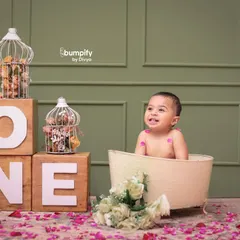 A big, happy smile from the birthday boy in his tub. This 'splash' session is a great alternative or addition to a cake smash, celebrating the first birthday with bubbles and fun.