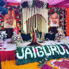 For this outdoor satsang, I created a vibrant stage with red and white floral pillars. The highlight is the "JAI GURU JI" message written entirely with fresh white flowers, placed right at the front of the stage.