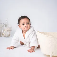 All wrapped up in a cozy white robe after a fun splash. This setup is simple, clean, and focuses entirely on your baby's adorable post-bath look.