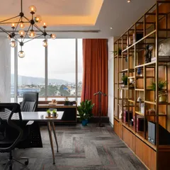 An executive cabin should feel powerful and inspiring. I designed this space with a stunning view, a bold sputnik chandelier, and a custom gold-finished shelving unit that adds a touch of luxury without being stuffy. It’s a workspace that makes a statement.