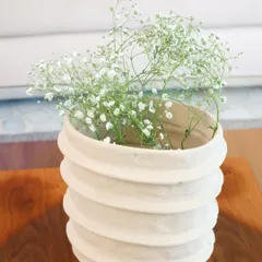 The same Moonlit Ivory vase, holding a simple spray of baby's breath. This showcases its ability to bring a touch of understated elegance and simplicity to your space.