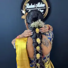 Professional hairstyling is a key part of my course. Here, you can see a traditional South Indian bridal braid, beautifully decorated with fresh flowers and hair accessories, a skill that is in high demand.