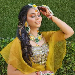 A candid shot of the model in the mehendi outfit, showing the flowy cape and the comfortable yet stylish design.