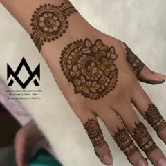 This party mehendi features a stylish mandala on the back of the hand with a matching wristband and finger details.