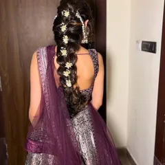 A back view of the full braid, showcasing its length and the beautiful placement of the flowers. This is a popular hairstyle for brides in Delhi and Noida.