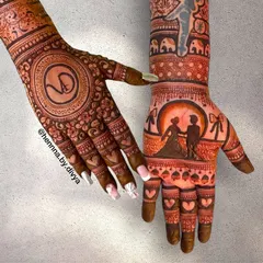 This engagement mehendi tells a story across two hands. One hand features a romantic couple silhouette against a full moon, while the other has the couple's monogram 'VD' inside a detailed mandala.