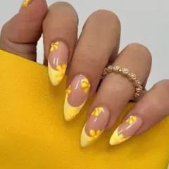 This set features bright yellow French tips on almond-shaped nails, decorated with delicate, hand-painted 3D flowers. It's a cheerful and trendy look for the summer season.