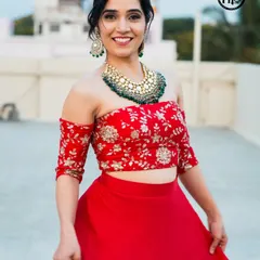 This bright and happy look is perfect for a sangeet or daytime party. The makeup is fresh and radiant, with a pop of color on the lips and softly defined eyes, paired with a modern off-shoulder lehenga.