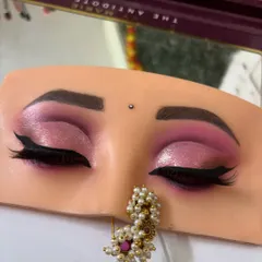 A close-up of the finished pink cut crease eye makeup, complete with a sharp winged liner. This look is perfect for sangeet or reception events.