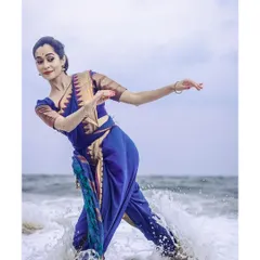 Dancing in the waves. The splash of the water adds an unpredictable and dynamic element to the photograph, capturing a moment of spontaneous connection with nature.