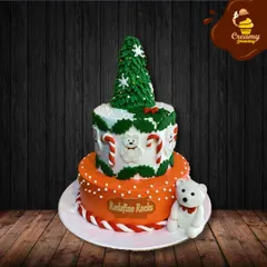 Another take on a Christmas theme, this two-tier cake features a buttercream Christmas tree topper and a cute fondant polar bear. The design combines classic holiday elements like candy canes and holly leaves.