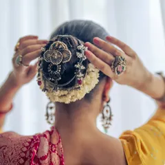 A close-up of the intricate hair jewels, a mix of designer pieces and vintage buttons I found in a small shop in Jaipur, adorning a traditional bun.