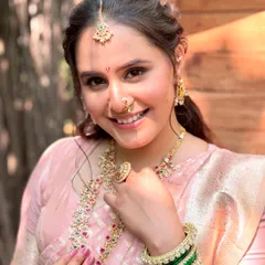 A close-up showcasing the delicate details of her Maharashtrian bridal makeup. The traditional nath and bindi are paired with a luminous base and soft eye makeup for a timeless look.