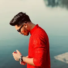 A closer look at the detailed fabric of the red Lucknowi kurta. The intricate self-design embroidery gives the piece a rich texture and a premium feel.