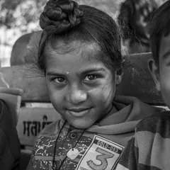 A close-up from the group sitting on the bench. This framing brings you closer to the children, allowing you to see the subtle smiles and curious looks on their faces.