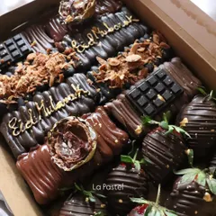 A decadent "Eid Mubarak" dessert box filled with chocolate-covered treats and chocolate-dipped strawberries.