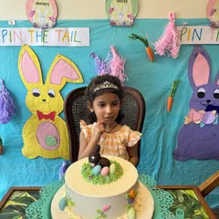 An Easter-themed birthday celebration! This little one is about to enjoy her beautiful cake, surrounded by the bunny and carrot decorations we made during the art session.