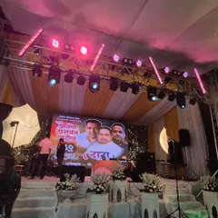 The same stage, but with the lighting changed to a vibrant pink. This shows the versatility of using programmable lights to completely alter the mood and color scheme of the event space in an instant.