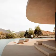 The Amar Villa in Udaipur, a boutique hotel designed as a seamless calligraphic curve that follows the site's natural topography. The architecture is designed to maximize breathtaking mountain views while blending into the surrounding landscape.
