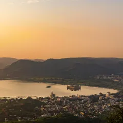 A stunning landscape shot of Jal Mahal in Jaipur at sunset. This sets the scene for the kind of epic, beautiful backdrops we use for destination shoots.