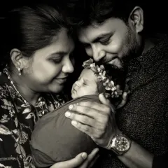 A family portrait is more than a photo; it's a memory of love. In this black and white shot, I wanted to capture the pure emotion and connection as parents gaze at their newborn.