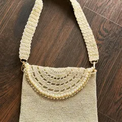 This elegant gold bag, detailed with delicate pearls, is designed to be your go-to accessory. It effortlessly complements both ethnic and western outfits, adding a touch of glamour to any look.