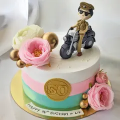 This cake was made for an actress celebrating her role as a police inspector. It features a custom, hand-sculpted figurine of her character on a motorcycle, combined with soft floral elements for a beautiful contrast.