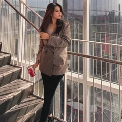 A confident pose on a staircase, this shot is part of my "on-the-go college outfit" series. The modern, sunlit architecture provides a great backdrop for this smart-casual look.