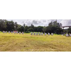 A wide-angle view of the competition range in Mumbai, showing multiple targets set up across the field for a large-scale event.