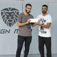 The captain of the winning team, "The Roll Models," receiving the cash prize after a dominant performance at our in-house event.