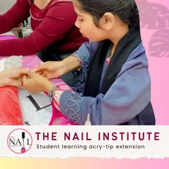 Here, a student is learning to apply and blend acry-tip extensions, a fundamental skill for creating length and strength.