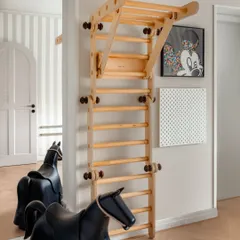 We believe homes should be for living, not just for show. This corner of the children's play area, with its wooden climbing frame and rocking horse, is a testament to creating spaces that are a little imperfect and a lot of fun.
