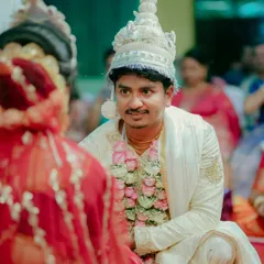 The groom's loving gaze at his bride during the wedding ceremony. This over the shoulder shot creates a personal and intimate perspective of their connection.