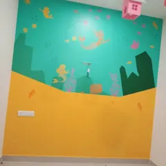 A whimsical mermaid and sea life mural in progress, designed to transform a child's bedroom into a magical underwater world.