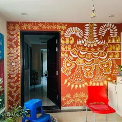 The completed 'Ethnic Ether Mural' in its full glory. The ivory and gold patterns flow around the doorway, creating a grand and festive entrance that completely transforms the space.