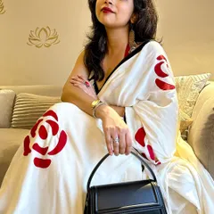 A close-up of my modern date night saree look. The bold red lip and structured black handbag are key accessories that pull the entire outfit together, making the hand-painted details on the saree pop.